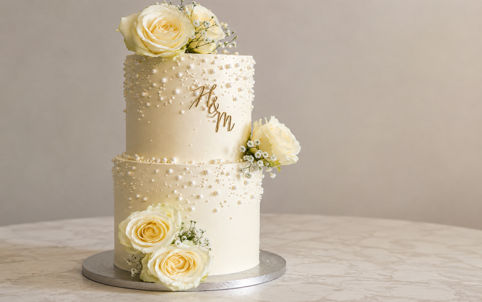 Elegant two tier ivory wedding cake with white roses in Ayodhya