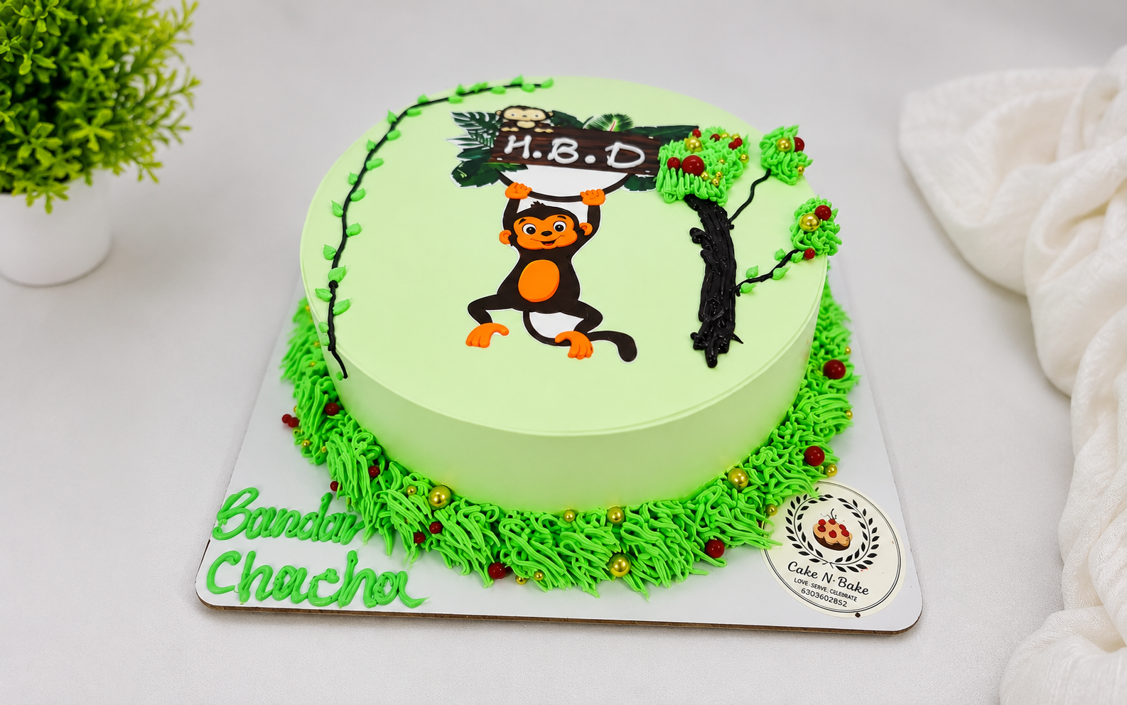 Green monkey theme birthday cake with jungle tree and HBD topper